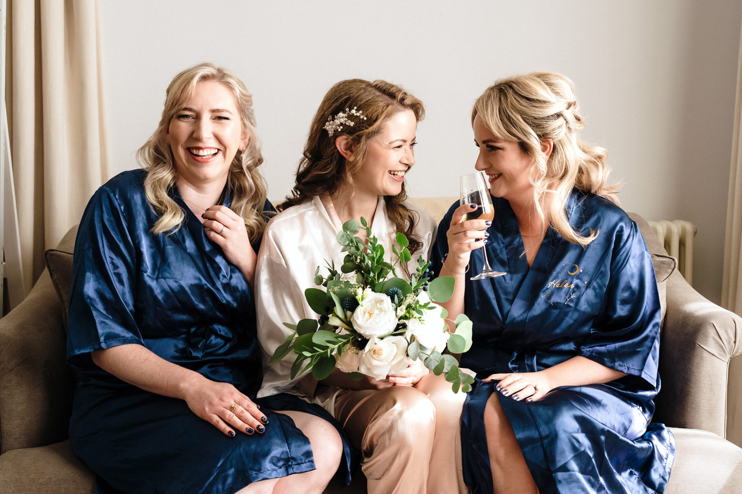 Bridal party wearing robes on a sofa