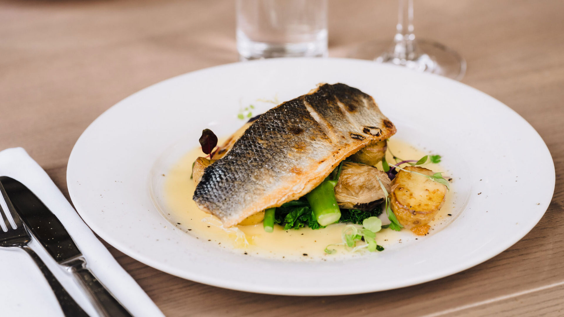 A fillet of fish on a bed of vegetables