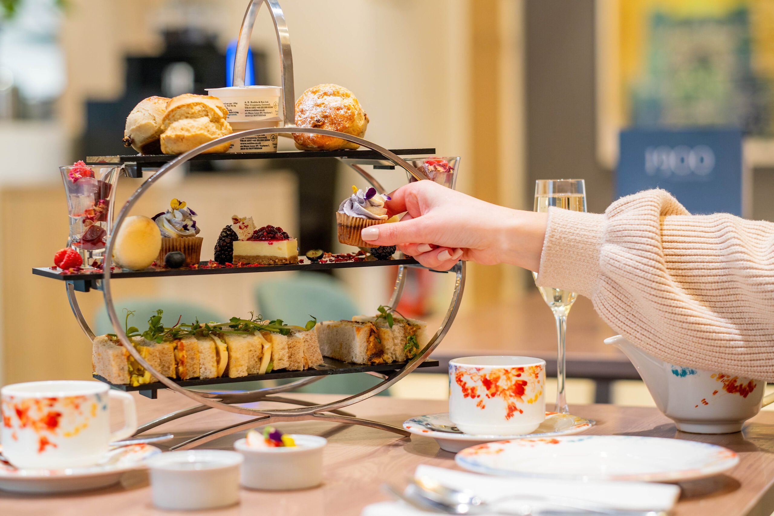 A guest picking off the afternoon tea