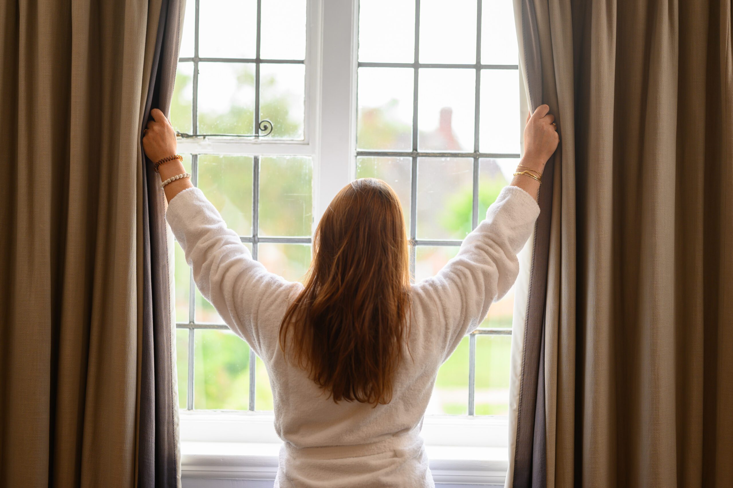 A guest opening the curtains