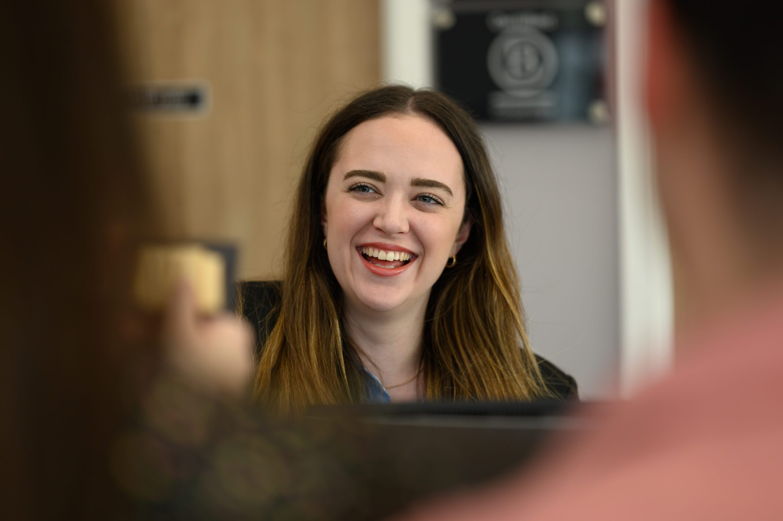 A member of staff smiling