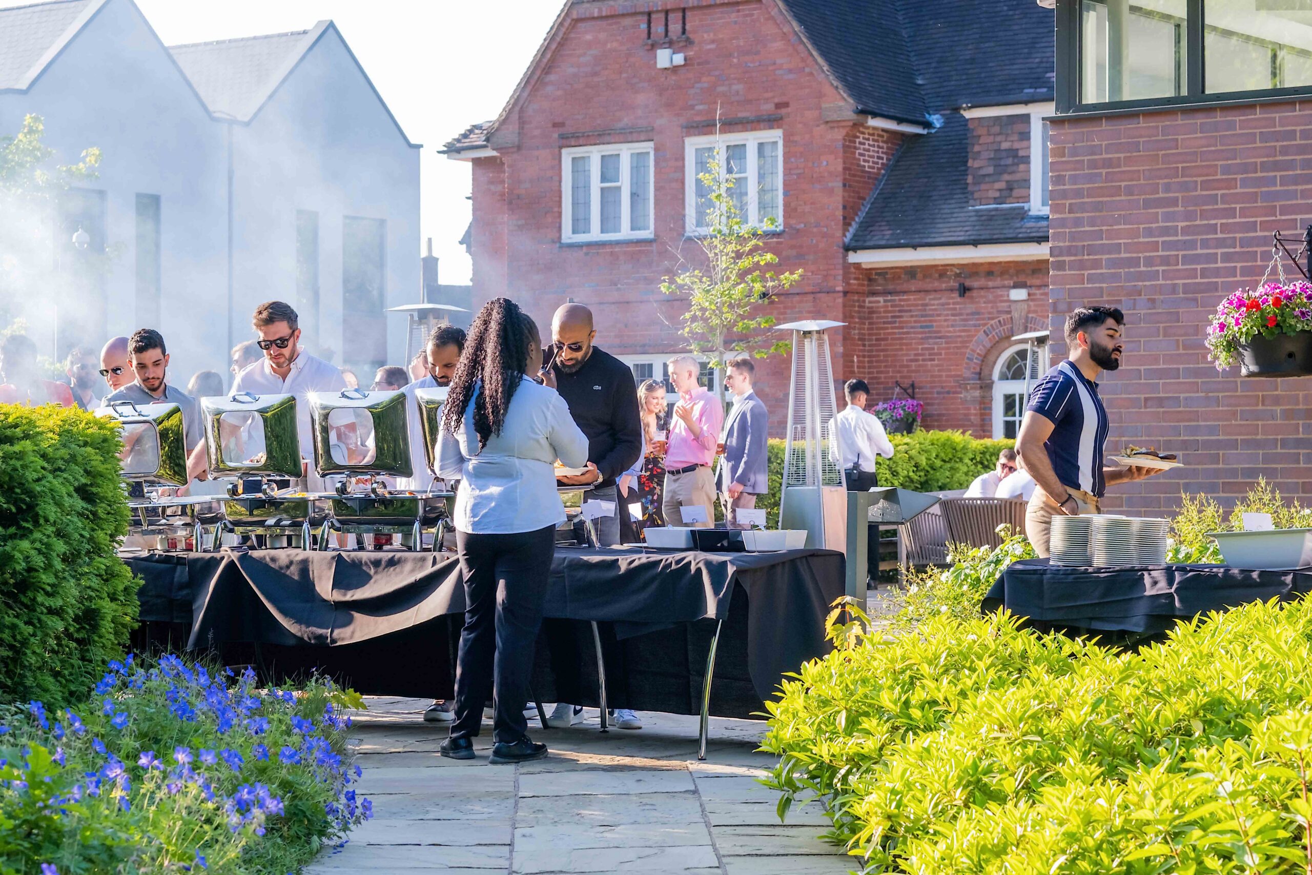 Guests being served BBQ food outside
