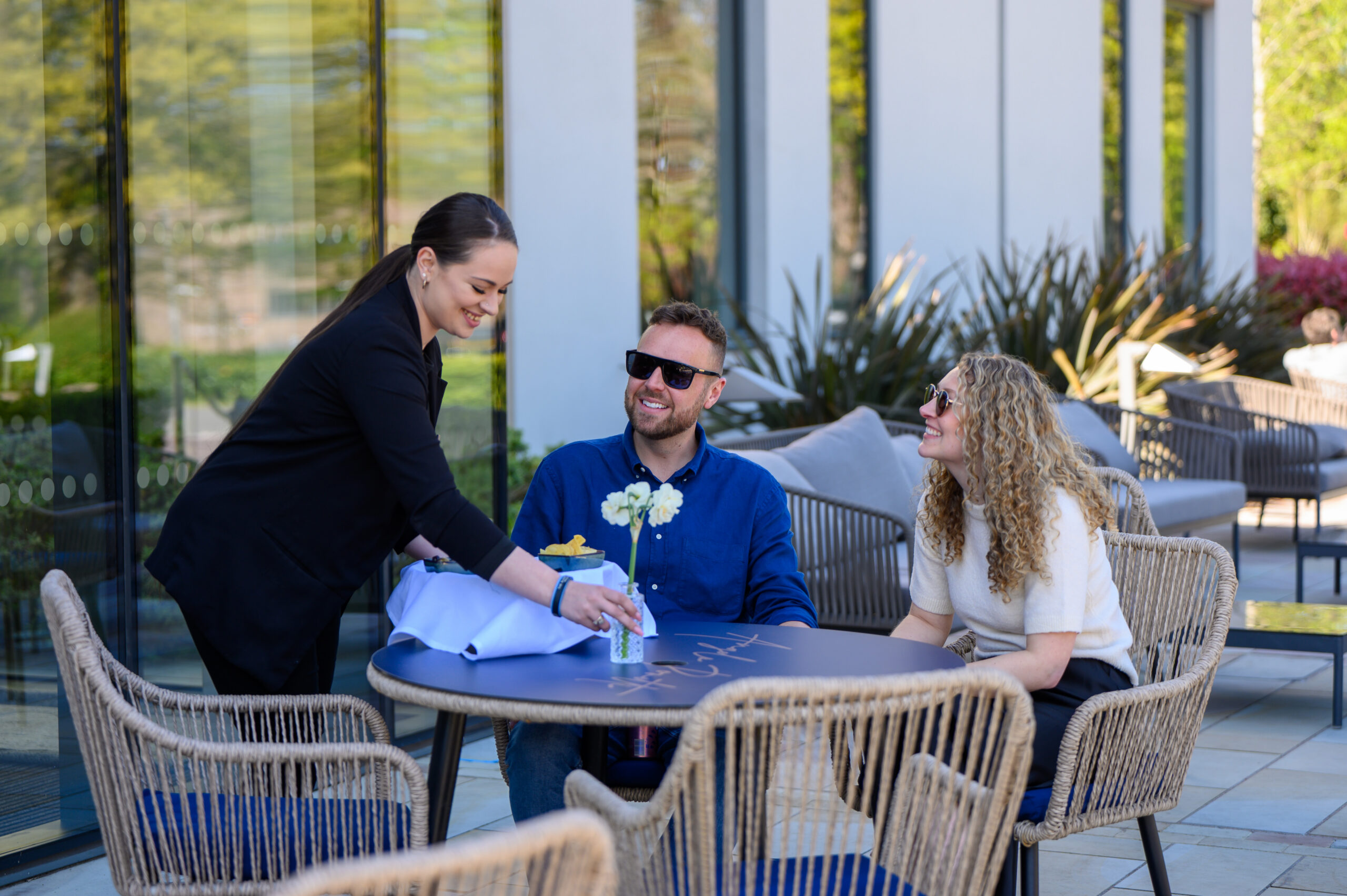 Two guests being served food outside