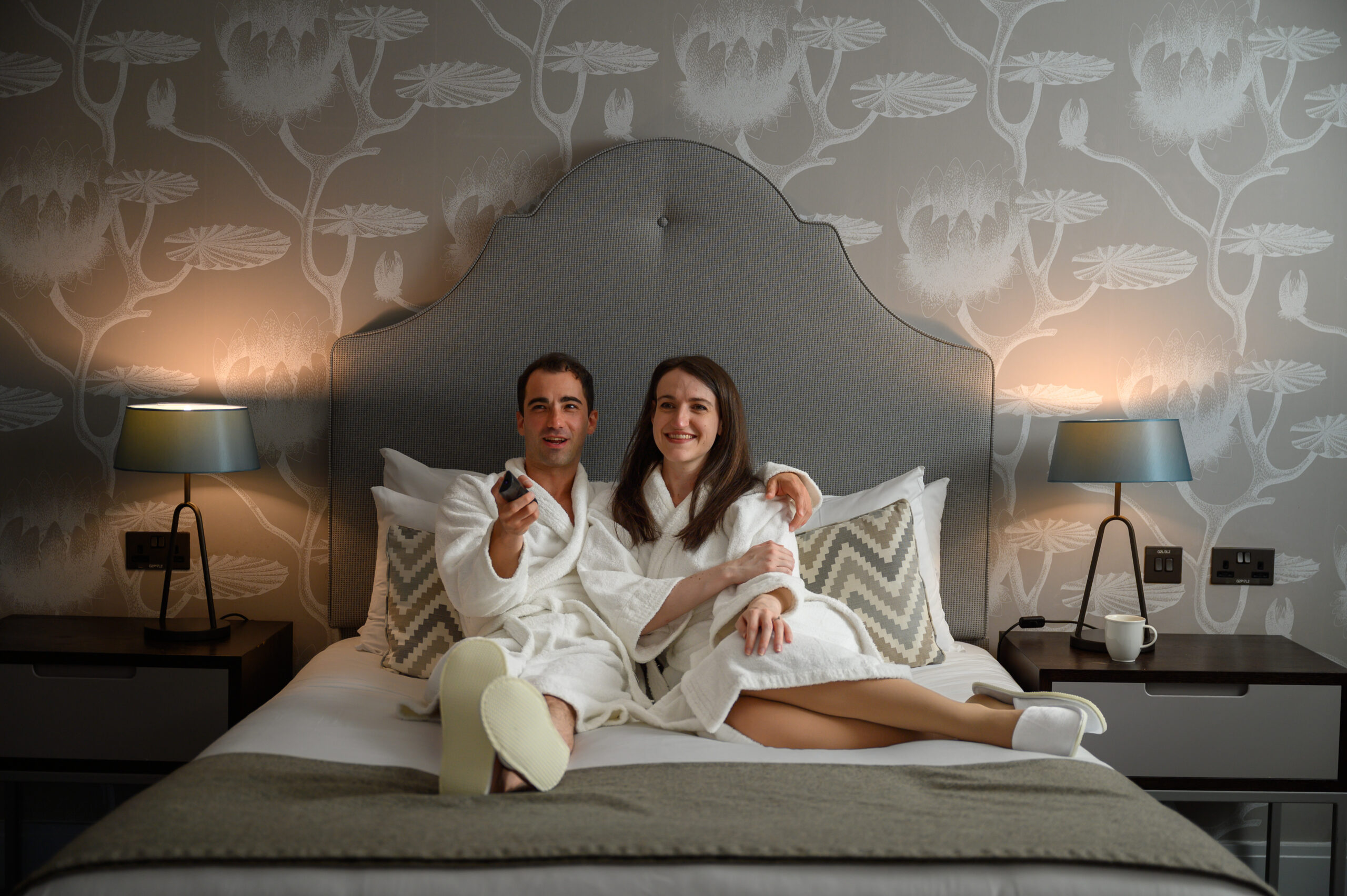 A couple in bed together deciding what to watch