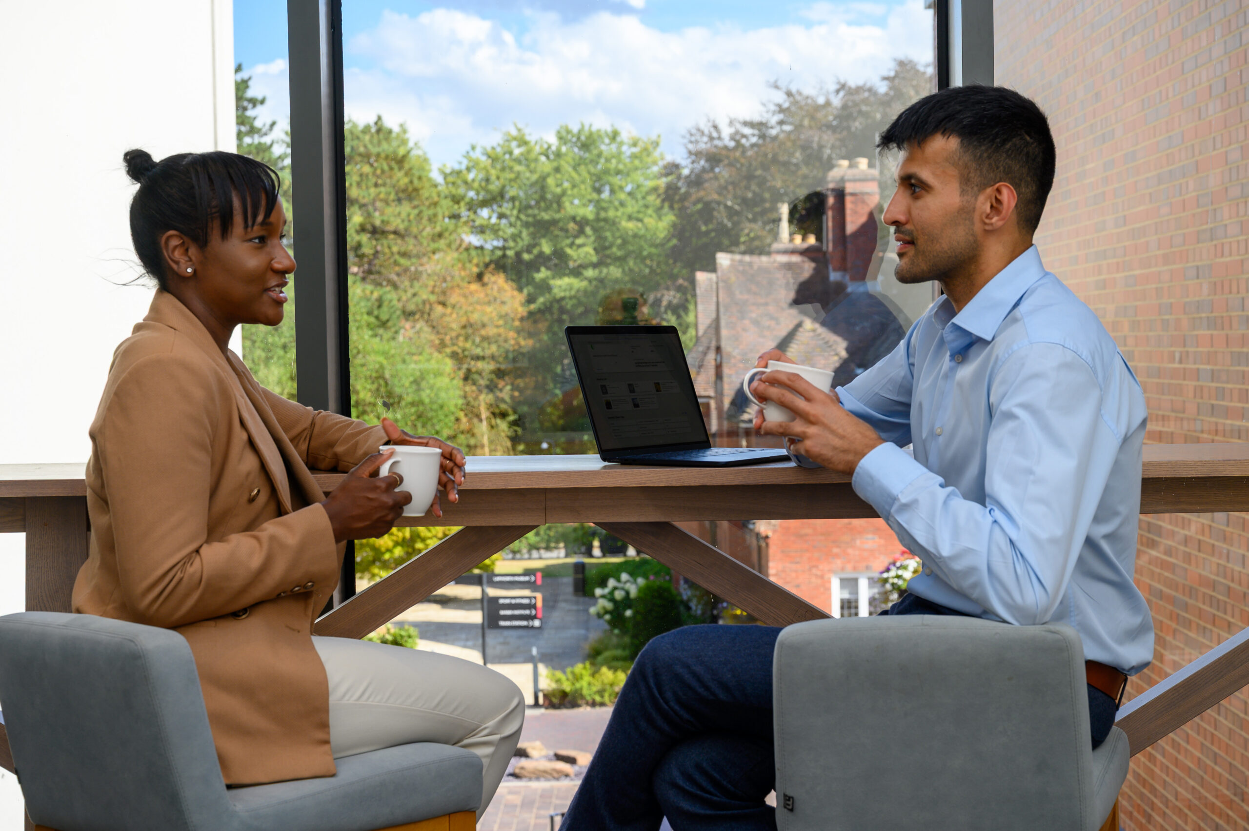 Two people having a chat over coffee