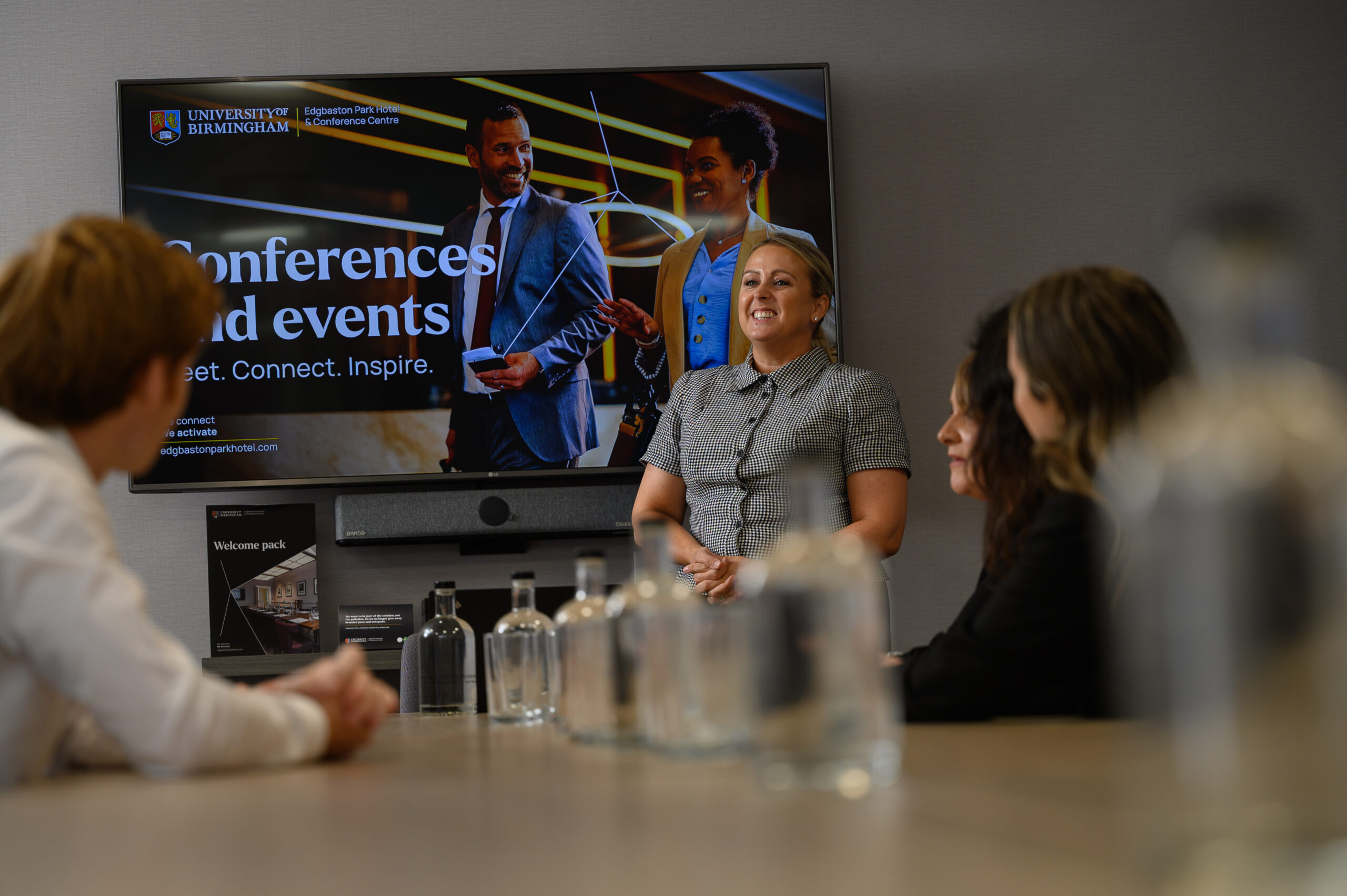 Person presenting to people sat around a table
