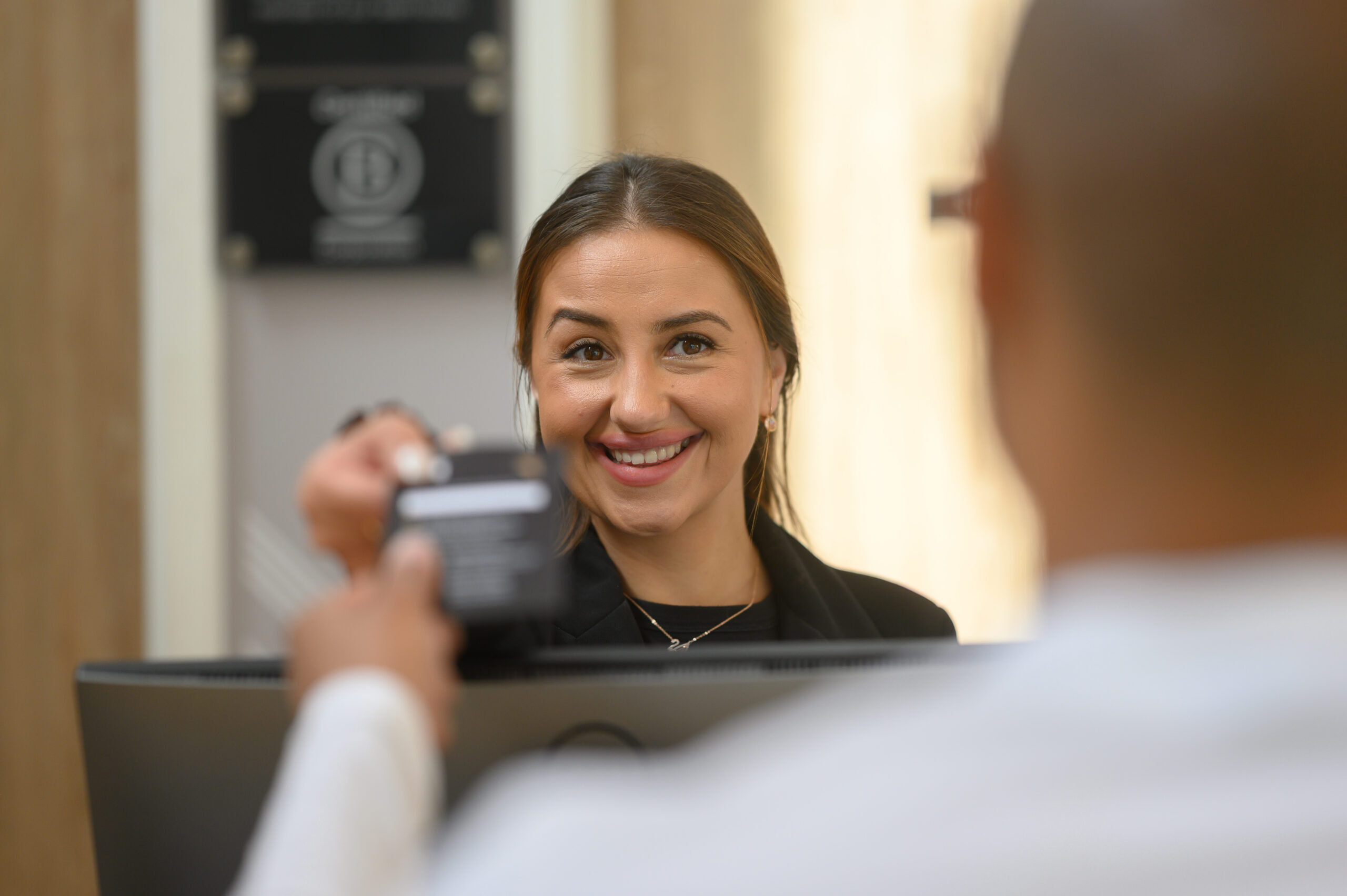 Reception team member checking guest in